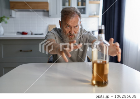 Portrait of senior man suffering from alcoholism Portrait of senior man suffering from alcoholism 106295639