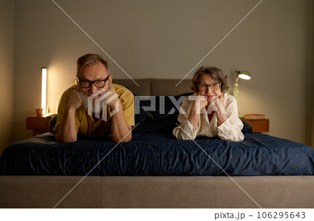 Portrait of smiling senior family couple in bed Portrait of smiling senior family couple in bed 106295643
