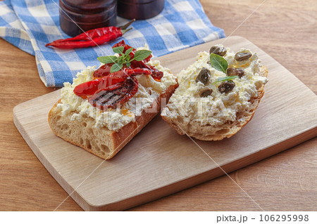 bruschetta with soft cheese capers and tomato 106295998