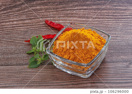 Yellow vibrant curcuma powder in the bowl 106296000