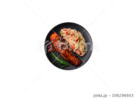 Delicious red salmon fish grilled with sauce and sesame seeds with rice and vegetables 106296603