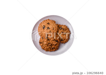 Delicious baked oatmeal raisin cookies on a dark concrete background Delicious baked oatmeal raisin cookies on a dark concrete background 106296640