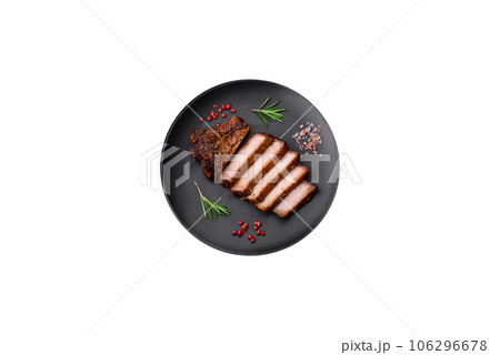 Delicious juicy pork steak on the bone with spices and herbs Delicious juicy pork steak on the bone with spices and herbs 106296678
