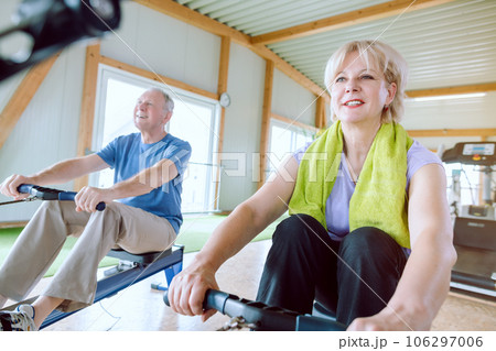 Senior couple in the gym on a rowing machine Senior couple in the gym on a rowing machine 106297006