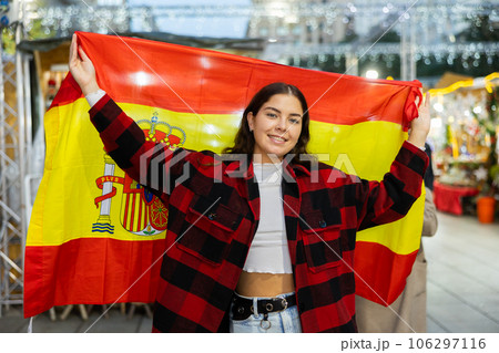 Girl waving Spain flag at street new year fair 106297116