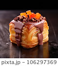 Delicious cube croissant with chocolate and caramel on a dark background 106297369