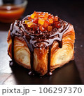 Delicious cube croissant with chocolate and caramel on a dark background 106297370