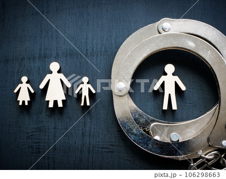 Family figurines and handcuffs as concept of domestic violence. Family figurines and handcuffs as concept of domestic violence. 106298663