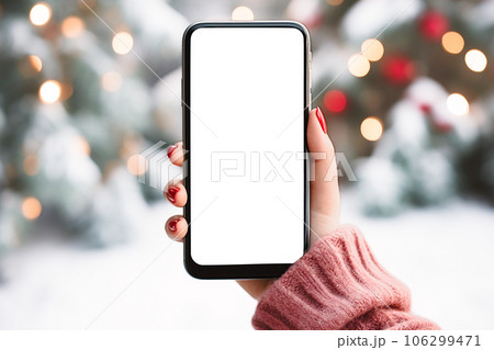 close-up smartphone in hand in winter evening day. smartphone with white empty display mockup close-up smartphone in hand in winter evening day. smartphone with white empty display mockup 106299471