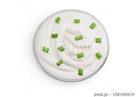 sour cream or yogurt in glass bowl isolated on white background with full depth of field. Top view. Flat lay 106300014