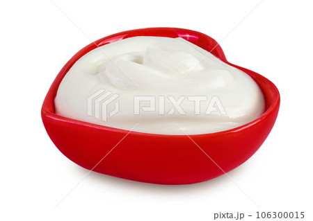 sour cream or yogurt in red ceramic bowl heart shaped isolated on white background with full depth of field 106300015