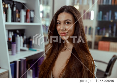 Beautiful brunette woman with long and shiny hair at beauty salon Beautiful brunette woman with long and shiny hair at beauty salon 106300896