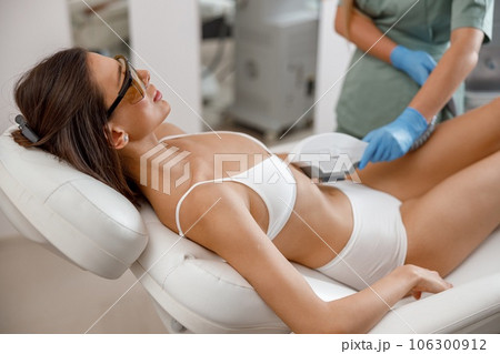 Cosmetology procedure with ipl machine from a professional cosmetologist in beauty salon 106300912