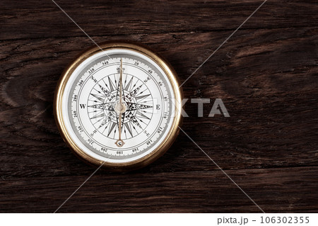 Vintage retro compass on wooden background 106302355