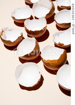 Cracked eggshell arranging on neutral background. 106303049