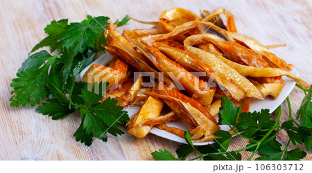 Smoked salmon belly strips with parsley Smoked salmon belly strips with parsley 106303712
