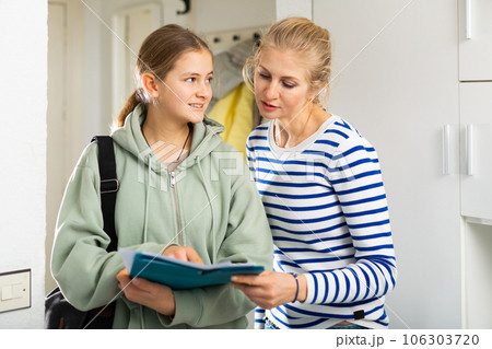 Woman answers questions of interviewer at home 106303720