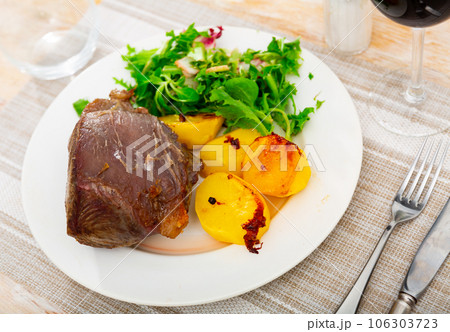 Piece of juicy appetizing delicious grilled beef with vegetables salad served with fried potato Piece of juicy appetizing delicious grilled beef with vegetables salad served with fried potato 106303723