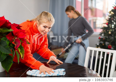 Mother and daughter cleaning room together before christmas Mother and daughter cleaning room together before christmas 106303746