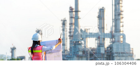 Engineers woman holding blueprint and report schedule for workers security control at power plant Engineers woman holding blueprint and report schedule for workers security control at power plant 106304406