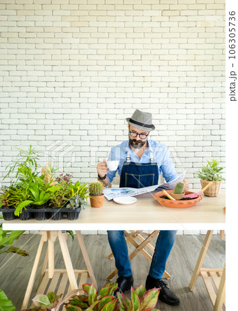 Hipster elderly men drink coffee,  read newspapers rest, and take care of plants, a hobby of urban home gardening after sustainable retirement Hipster elderly men drink coffee,  read newspapers rest, and take care of plants, a hobby of urban home gardening after sustainable retirement 106305736