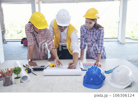 Civil Construction engineer teams shaking hands together wear work helmets worker on construction site. Foreman industry project working engineer teamwork. Two asian engineer team shake hands together 106306124