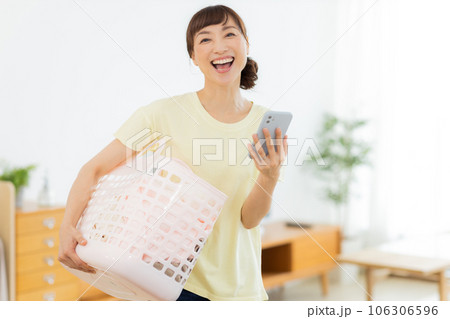 女性　洗濯　携帯電話　リビング 106306596