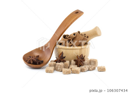 Star anise, cinnamon sticks and brown sugar on white 106307434