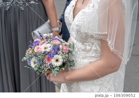 Bride holding Bouquet in female hands. Flowers for the wedding Bride holding Bouquet in female hands. Flowers for the wedding 106309052