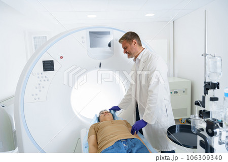 Doctor and female patient in the room of computed tomography at hospital. Healthcare concept 106309340