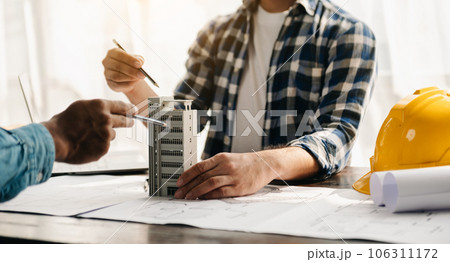 Engineer teams meeting working together wear worker helmets hardhat on construction site in modern city.Asian industry professional team 106311172
