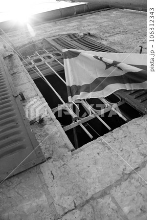 Flag of Israel on wooden pole in window. 106312343