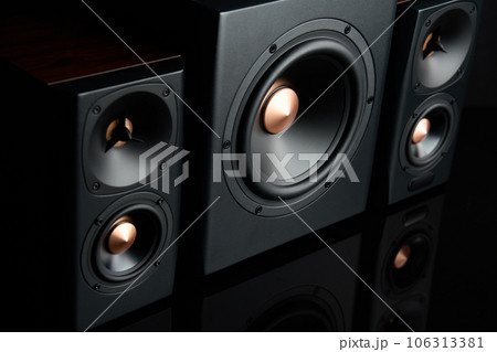 Sound audio system with two satellites and subwoofer on dark background. Sound audio system with two satellites and subwoofer on dark background. 106313381