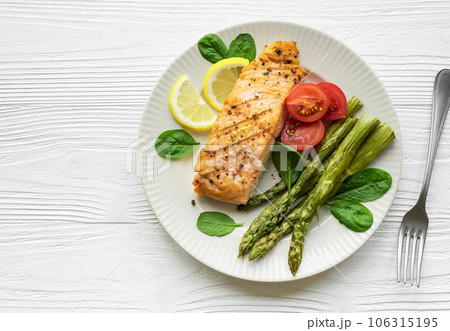 Baked Delicious salmon, green asparagus on plate Baked Delicious salmon, green asparagus on plate 106315195
