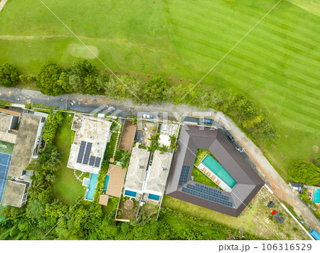 Aerial view drone Top down shot of beautiful green golf field with modern luxury villa, High angle view in summer day 106316529