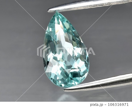 Natural gem blue tourmaline on a gray background 106316971