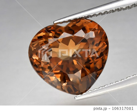 Natural gemstone orange topaz on a gray background. Imperial topaz, champagne topaz Natural gemstone orange topaz on a gray background. Imperial topaz, champagne topaz 106317081