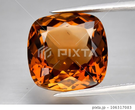 Natural gemstone orange topaz on a gray background. Imperial topaz, champagne topaz Natural gemstone orange topaz on a gray background. Imperial topaz, champagne topaz 106317083