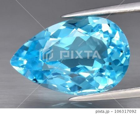 Natural gemstone blue topaz on a gray background Natural gemstone blue topaz on a gray background 106317092
