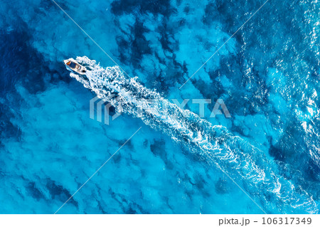 Vacation and leisure. Aerial view on fast boat on blue Mediterranean sea at sunny day.  106317349