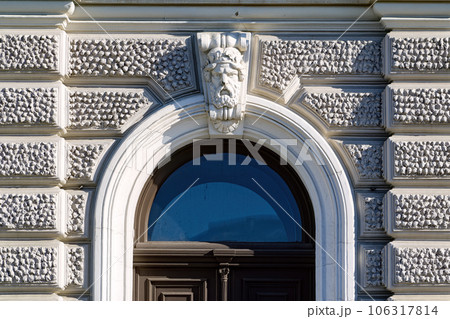 Detail of the facade, bas-relief or mascaron above the door of an old building in Moscow, Russia. Detail of the facade, bas-relief or mascaron above the door of an old building in Moscow, Russia. 106317814