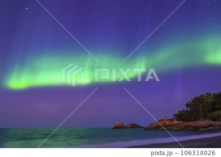 Northern Lights. Aurora. Iceland. Moment of greatest activity. Northern lights over the sea, snowy mountains. Starry sky. Winter landscape with aurora. Tree silhouette. Villages silhouette. 2023. Northern Lights. Aurora. Iceland. Moment of greatest activity. Northern lights over the sea, snowy mountains. Starry sky. Winter landscape with aurora. Tree silhouette. Villages silhouette. 2023. 106318026