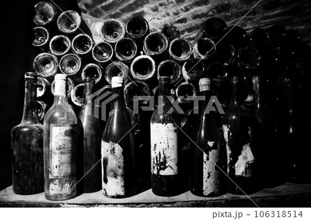 Very ancient bottles of wine lies in retro dark cellar Very ancient bottles of wine lies in retro dark cellar 106318514