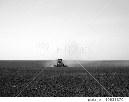 Plowed field by tractor in black soil on open countryside nature Plowed field by tractor in black soil on open countryside nature 106318704