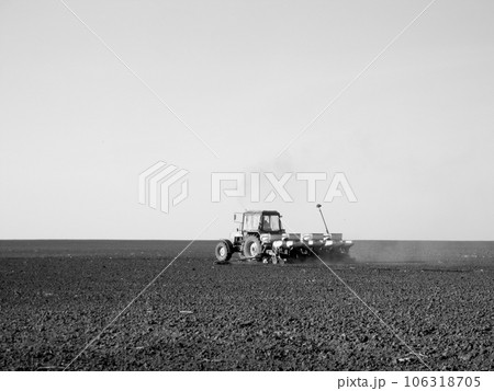 Plowed field by tractor in black soil on open countryside nature Plowed field by tractor in black soil on open countryside nature 106318705