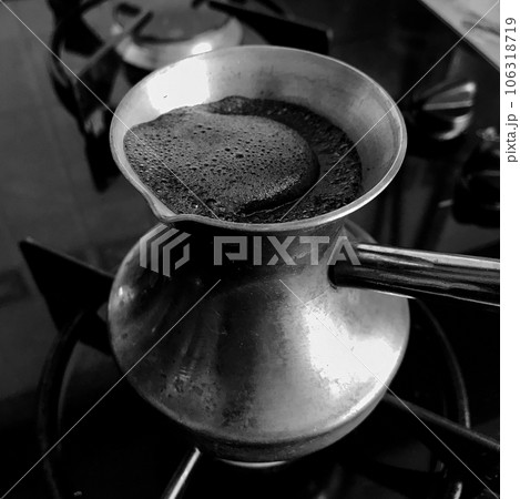 Barista preparing hot tasty drink from copper turk Barista preparing hot tasty drink from copper turk 106318719