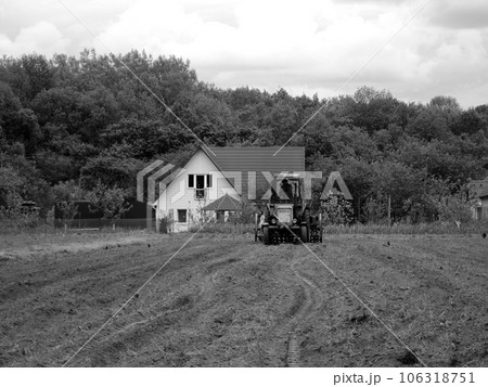 Plowed field by tractor in black soil on open countryside nature 106318751