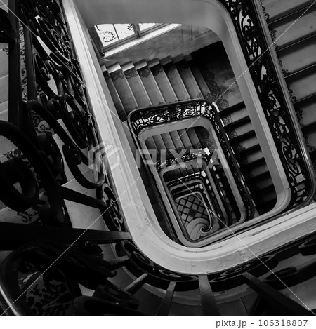 View bottom up on beautiful luxury staircase with wooden railings View bottom up on beautiful luxury staircase with wooden railings 106318807