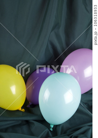 balloons in harmonious colors on a wavy green background 106318933