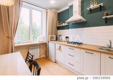 Modern Bright Kitchen In Scandinavian Stylish. Family Apartment With Dinner Table And Chairs. Idea For Home Design. Light Colors Of Design. Stylish Apartment Interior Of Kitchen, Kitchen Equipment 106319060